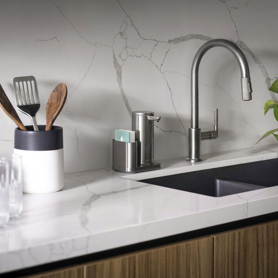 Simplehuman Brushed Stainless Steel 9 oz Sensor Pump and Caddy unit near kitchen sink, organized touch-free soap dispensing.