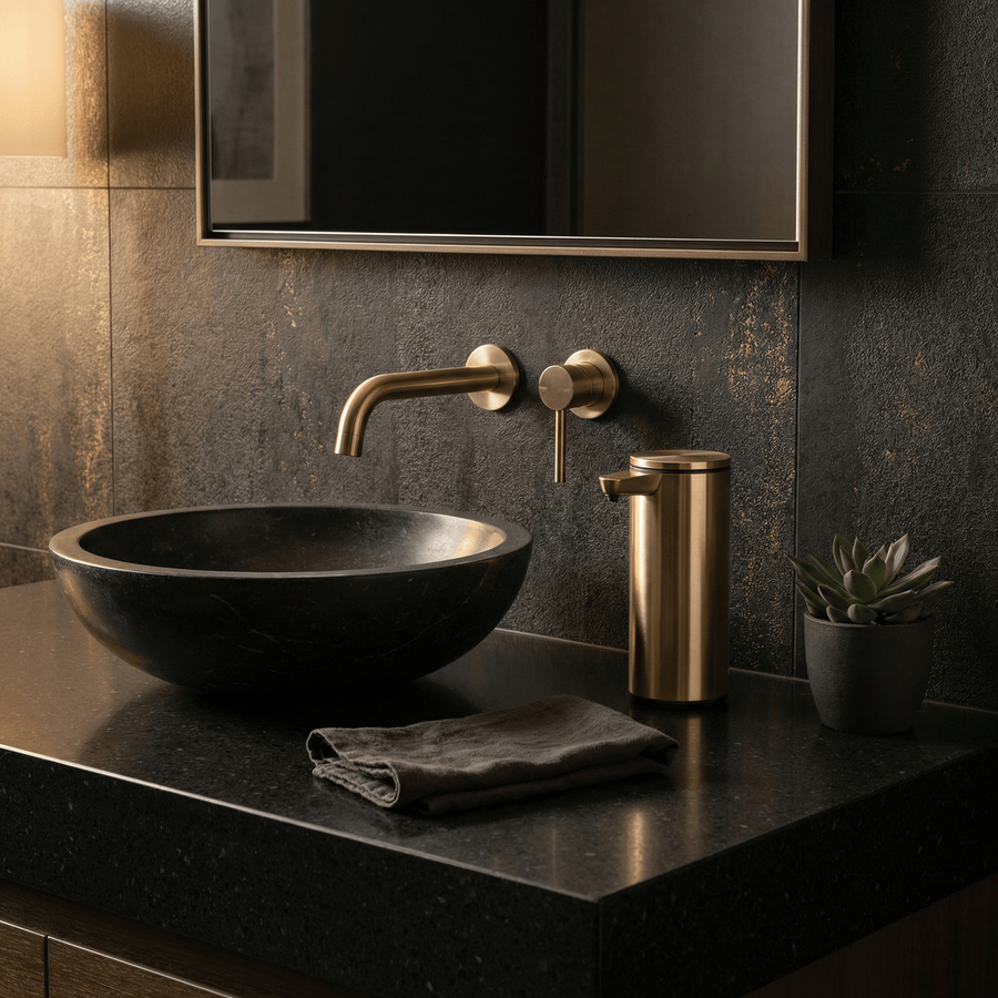 Simplehuman's 9 oz. Liquid Sensor Pump in Brass in a darker bathroom setting with black and gold appliances.