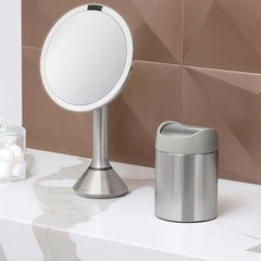 mini bin - brushed stainless steel w/ grey trim - lifestyle on counter with mirror and cotton balls image