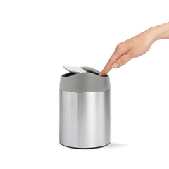 mini bin - brushed stainless steel w/ grey trim - lifestyle with hand image