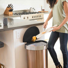 45L semi-round sensor bin - rose gold finish - lifestyle scraping food into bin in kitchen