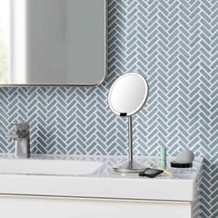 sensor mirror fold - brushed finish - lifestyle on bathroom sink with cosmetics image 