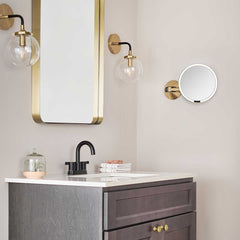 hard-wired wall mount sensor mirror - brass finish - lifestyle on wall image